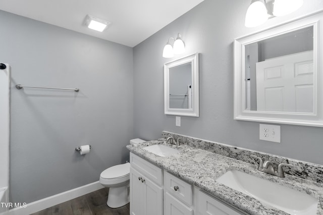 bathroom featuring hardwood / wood-style floors, vanity, and toilet