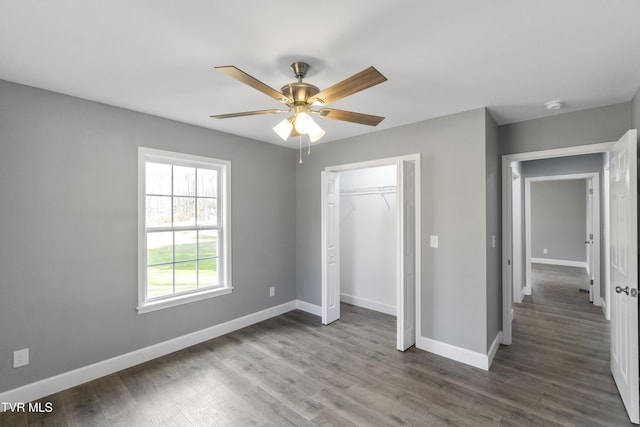 unfurnished bedroom with a closet, ceiling fan, and hardwood / wood-style floors