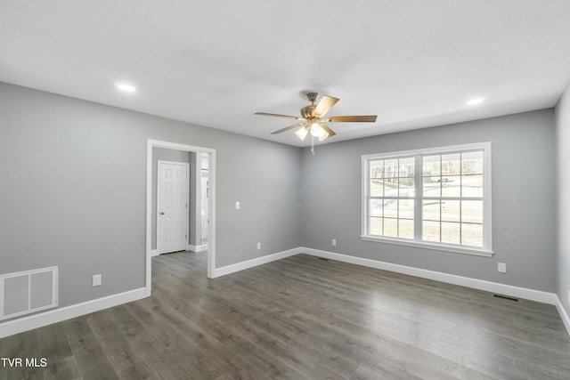 spare room featuring ceiling fan and dark wood-type flooring