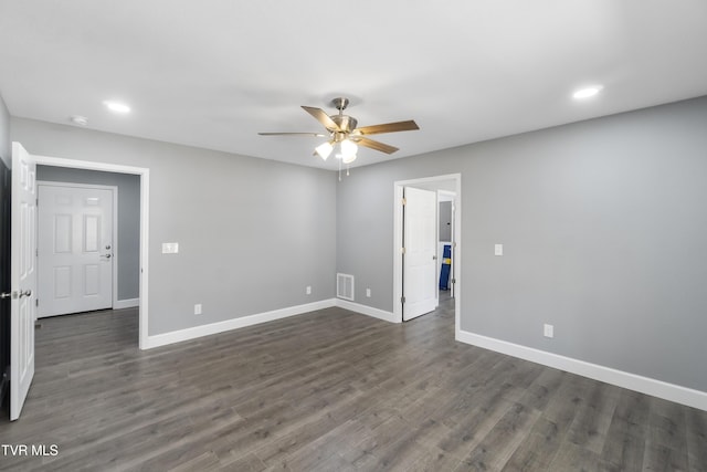 spare room with ceiling fan and dark wood-type flooring