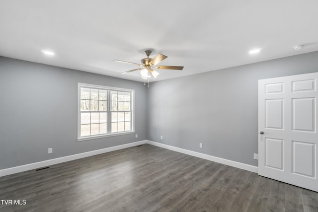 unfurnished room featuring ceiling fan and dark wood-type flooring