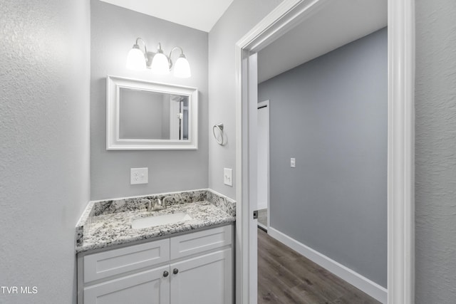 bathroom with vanity and wood-type flooring