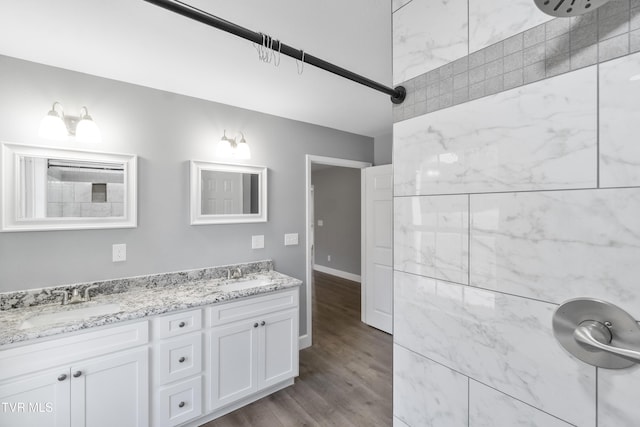 bathroom featuring vanity, wood-type flooring, and walk in shower