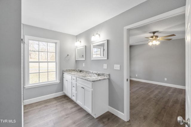 bathroom featuring ceiling fan, vanity, and hardwood / wood-style flooring