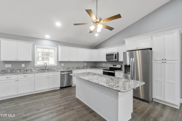 kitchen with white cabinetry, light stone counters, and appliances with stainless steel finishes