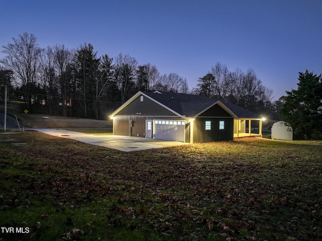 view of front of house featuring a garage and a storage shed