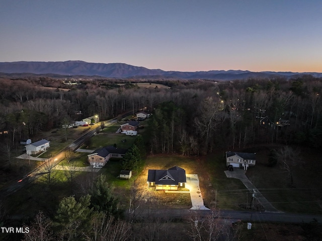 aerial view at dusk featuring a mountain view