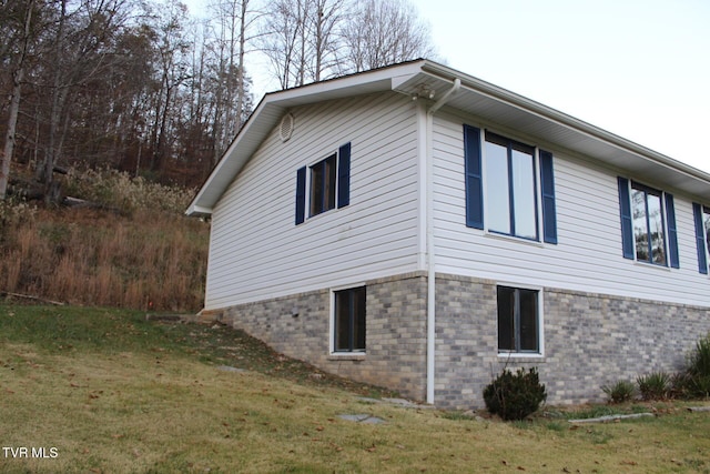 view of property exterior with a yard