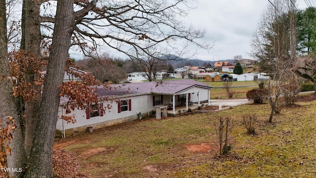 back of house featuring a lawn and a patio area