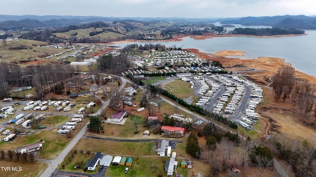 birds eye view of property with a water and mountain view