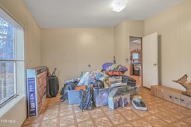 misc room with a textured ceiling and light parquet floors