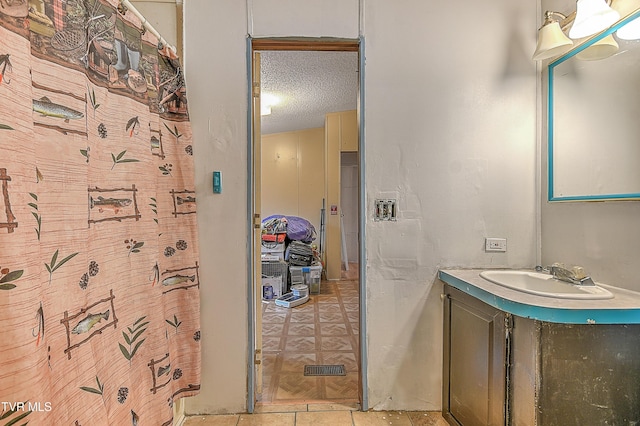 bathroom with vanity and a textured ceiling