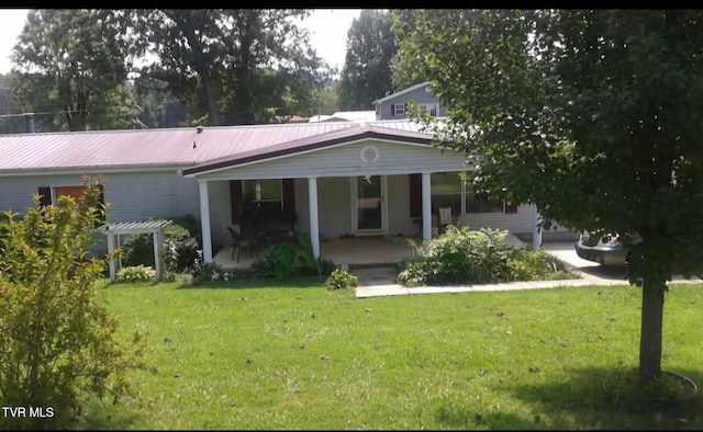 back of property with a porch, a pergola, and a yard