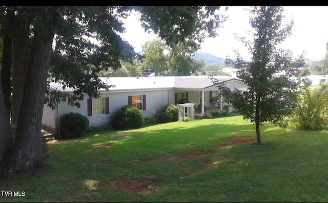 back of house with a lawn