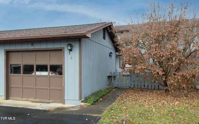 view of side of home featuring a garage