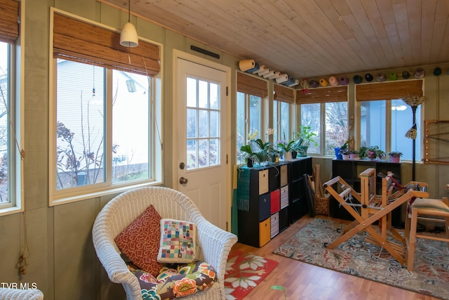 sunroom / solarium with plenty of natural light and wooden ceiling