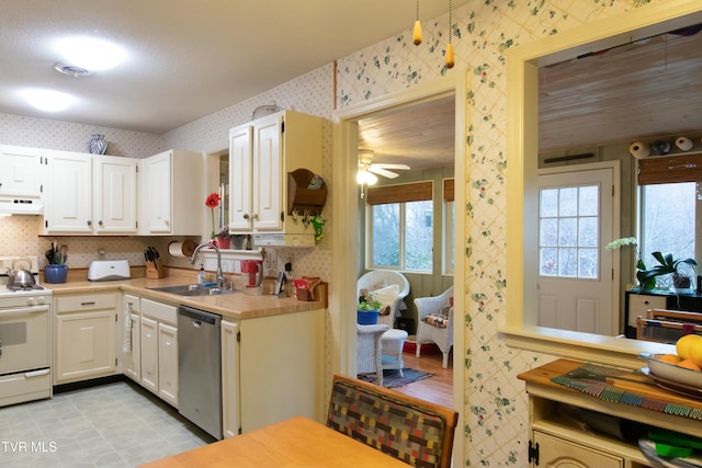 kitchen with stainless steel dishwasher, custom range hood, white range, sink, and white cabinetry