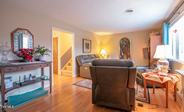 living room featuring light wood-type flooring and plenty of natural light