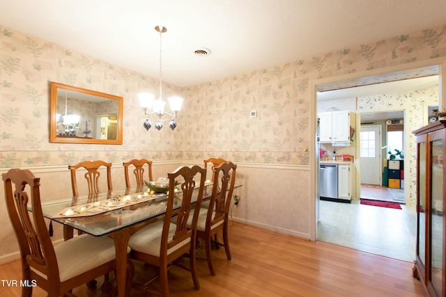 dining room featuring a chandelier and light hardwood / wood-style flooring