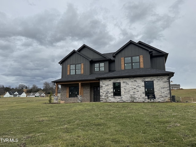 view of front of home with a front yard and cooling unit