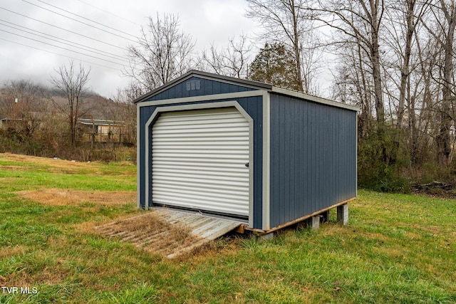 view of outbuilding with a yard