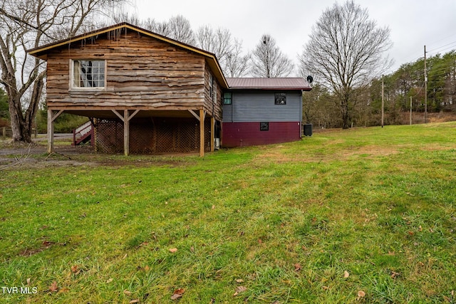 rear view of property featuring a yard