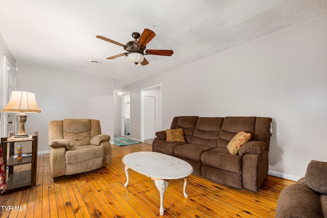 living room featuring light hardwood / wood-style floors and ceiling fan