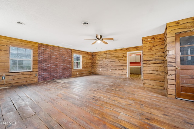 unfurnished living room featuring ceiling fan and wood-type flooring