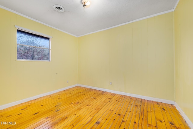 unfurnished room with crown molding and wood-type flooring