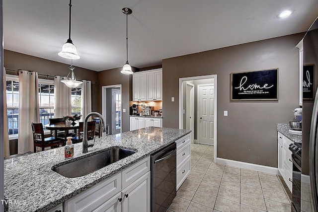 kitchen featuring pendant lighting, sink, light stone countertops, white cabinetry, and stainless steel appliances