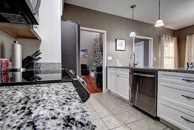 kitchen featuring pendant lighting, dishwasher, white cabinets, sink, and light tile patterned floors