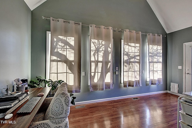 entryway with hardwood / wood-style floors and vaulted ceiling