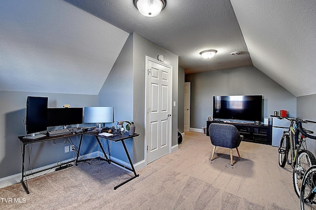 office featuring carpet flooring, a textured ceiling, and lofted ceiling