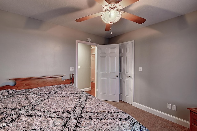 bedroom with ceiling fan, a closet, and light carpet