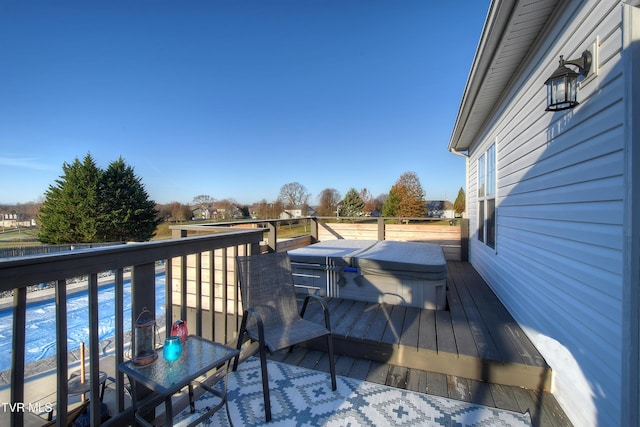 deck featuring a swimming pool with hot tub