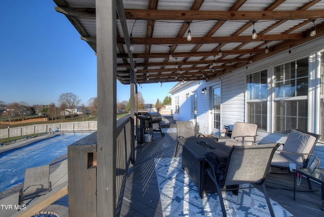 wooden deck featuring area for grilling and a covered pool