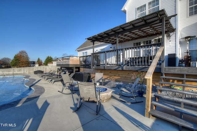 view of patio featuring an outdoor fire pit and a pool side deck