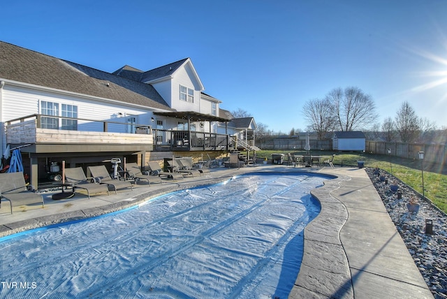 view of swimming pool with a patio and a wooden deck