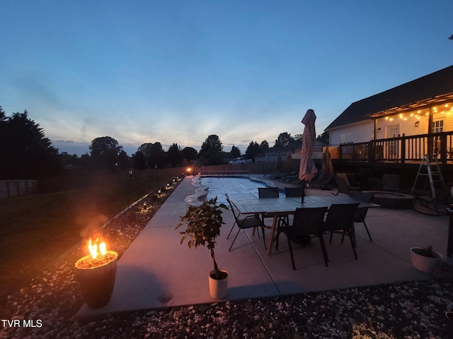 patio terrace at dusk featuring a fire pit