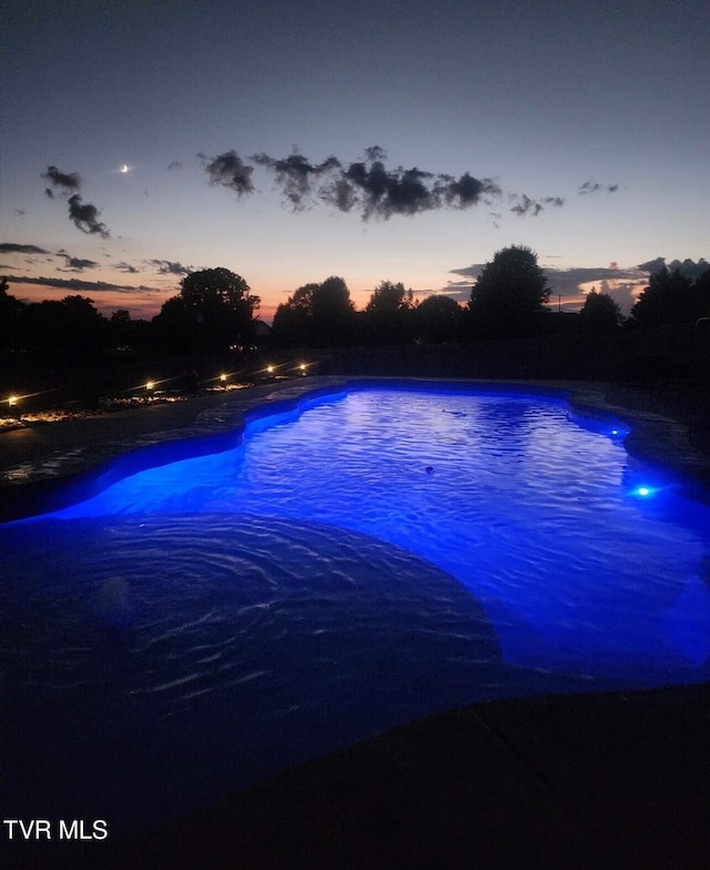 view of pool at dusk