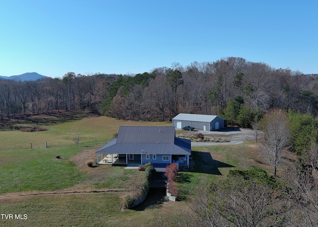 birds eye view of property with a view of trees