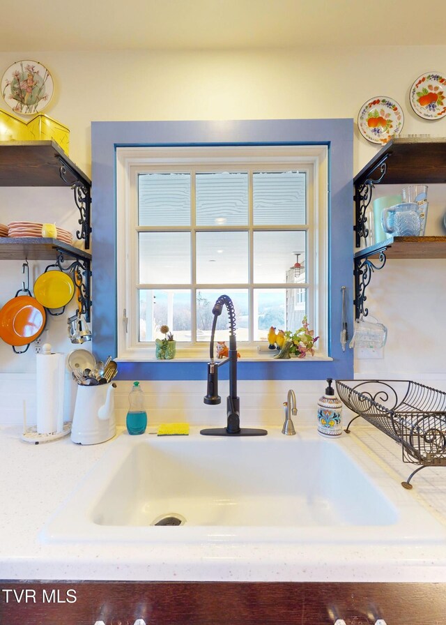 kitchen featuring light countertops and a sink