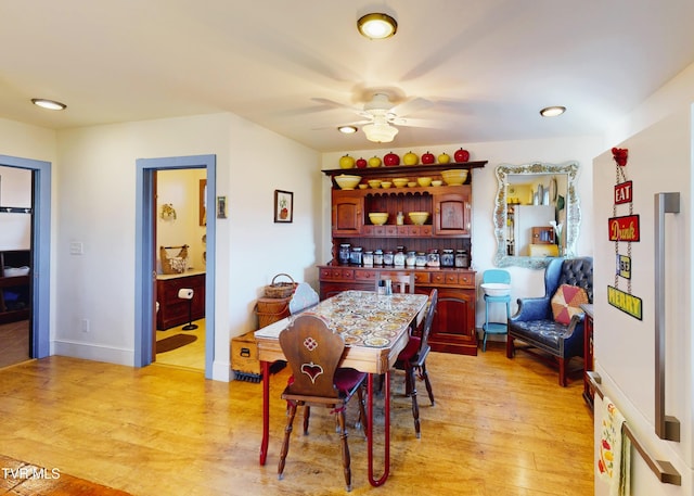 dining room with light wood-style floors, baseboards, a ceiling fan, and recessed lighting