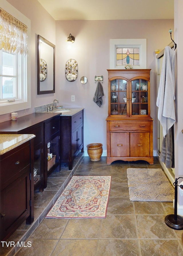 bathroom with vanity and baseboards