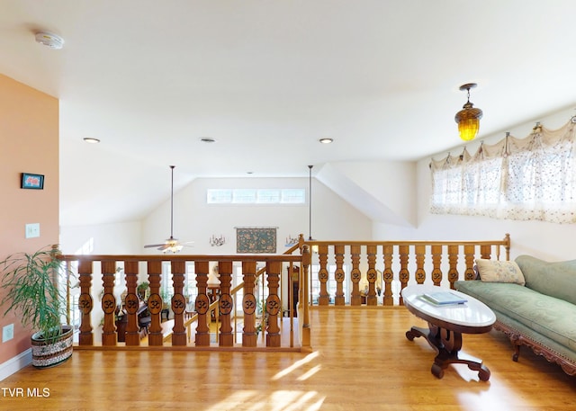 sitting room with lofted ceiling, a ceiling fan, and wood finished floors