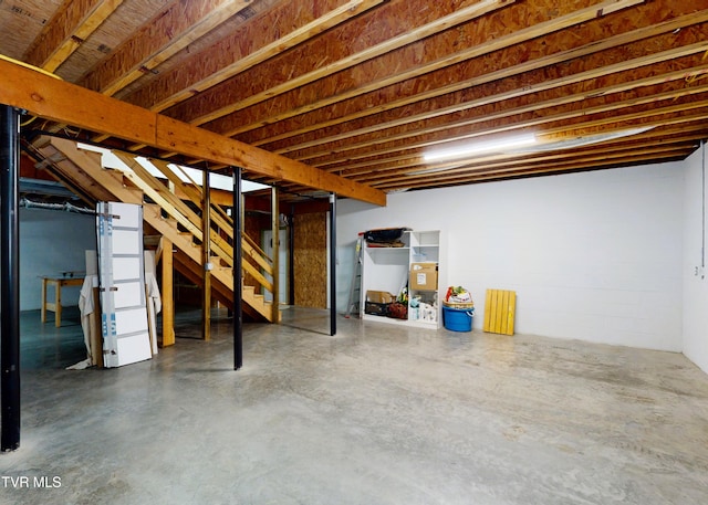 unfinished basement featuring stairway