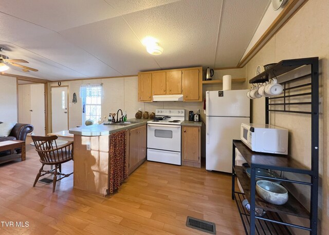 kitchen with under cabinet range hood, a peninsula, white appliances, visible vents, and light wood-type flooring