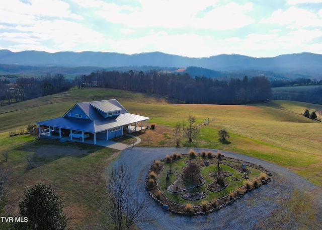 aerial view featuring a rural view, a wooded view, and a mountain view