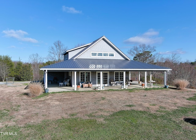 back of house featuring metal roof