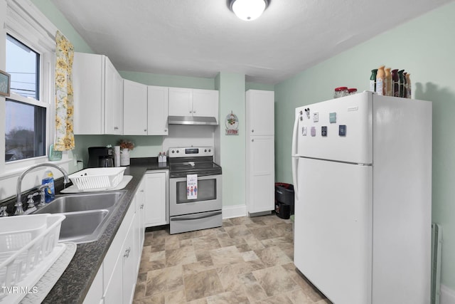 kitchen featuring white refrigerator, white cabinetry, stainless steel electric stove, and sink